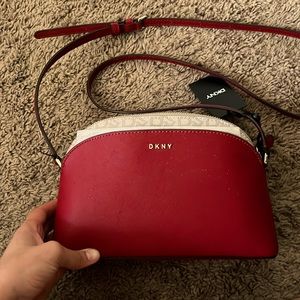 DNKY cross body. Red and tan with letters.